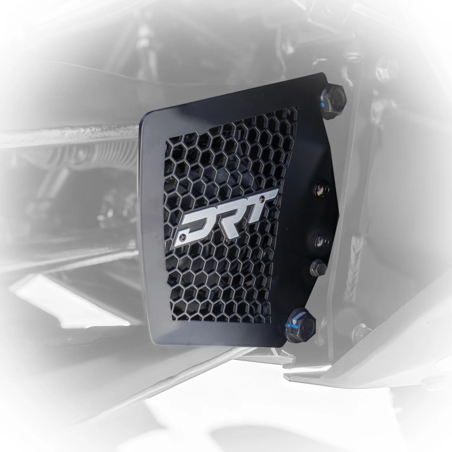 Black honeycomb grille with 'DRT' logo on a vehicle