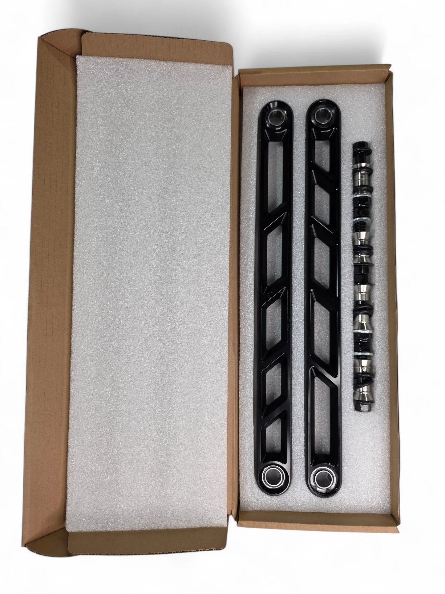 Set of black metal brackets in a cardboard box on a white background