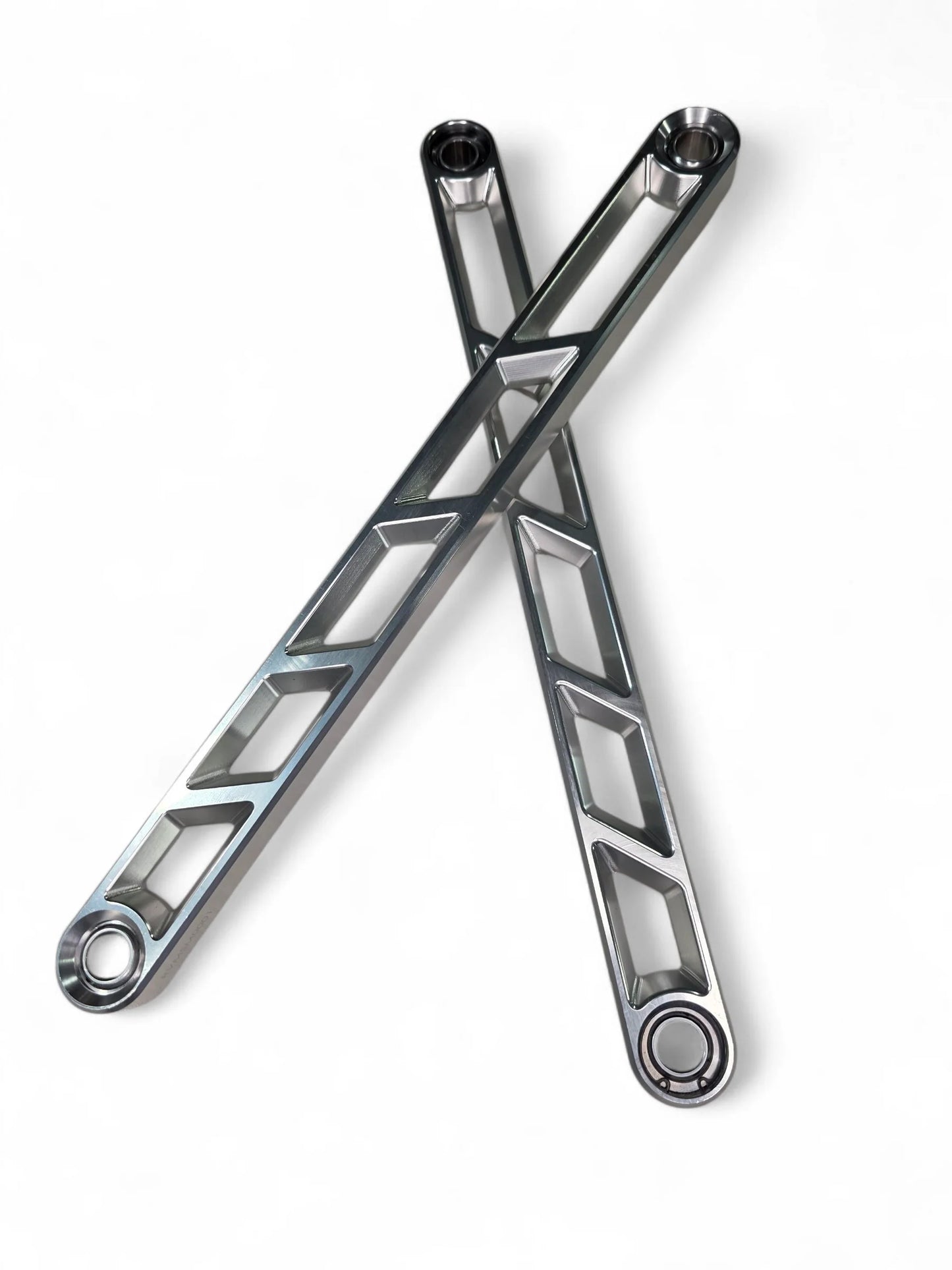 Two crossed metal wrenches on a white background