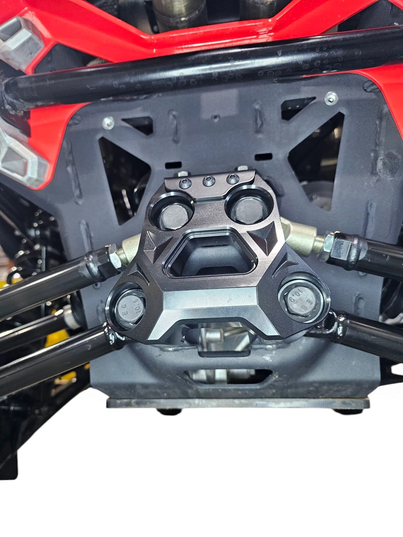 Close-up of a motorcycle's engine and frame on a white background