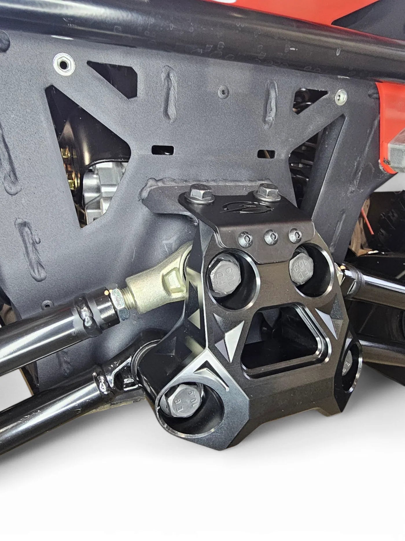 Close-up of a mechanical component with bolts and metal parts on a white background