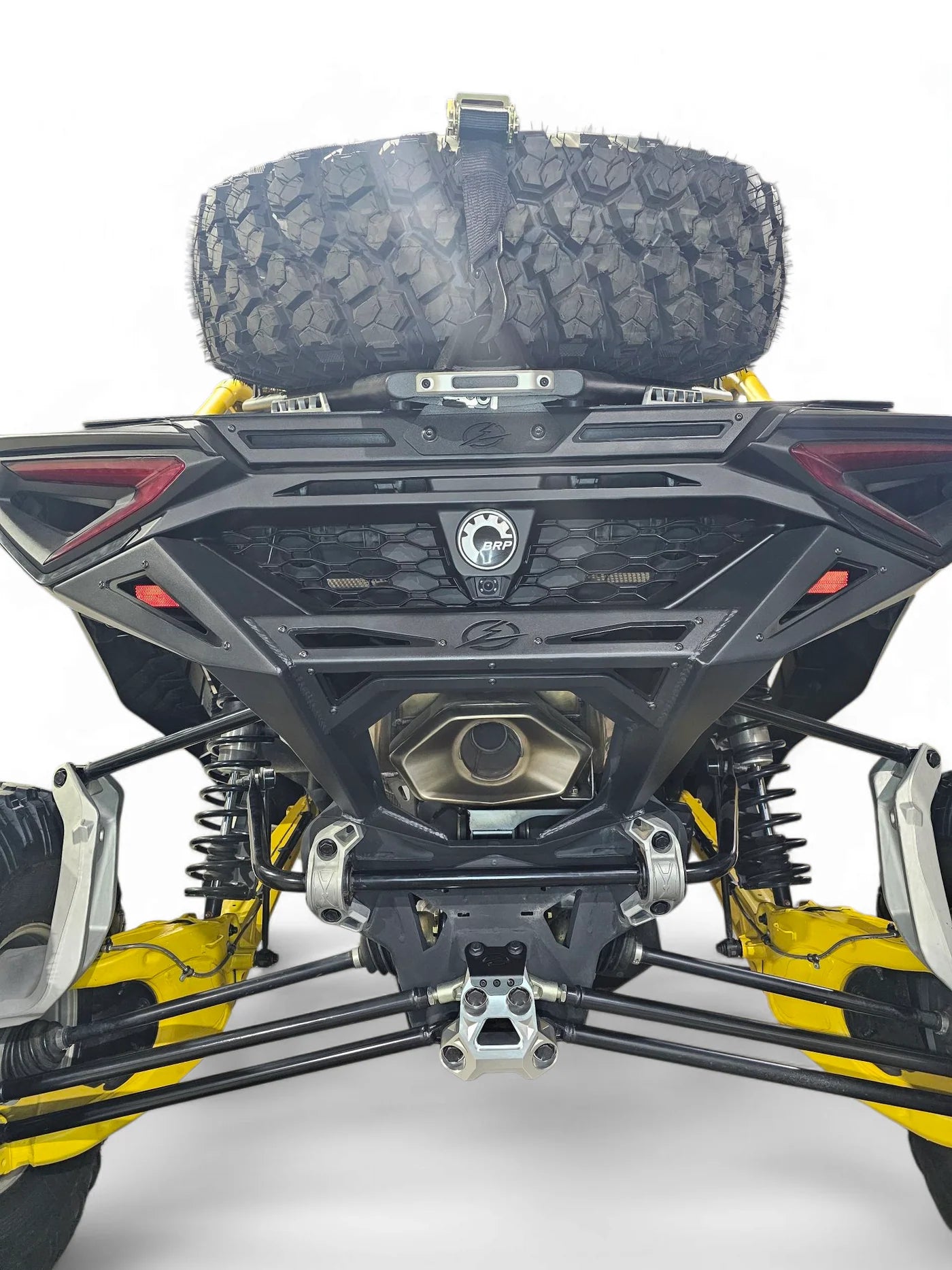 Close-up of an ATV with a spare tire mounted on a white background