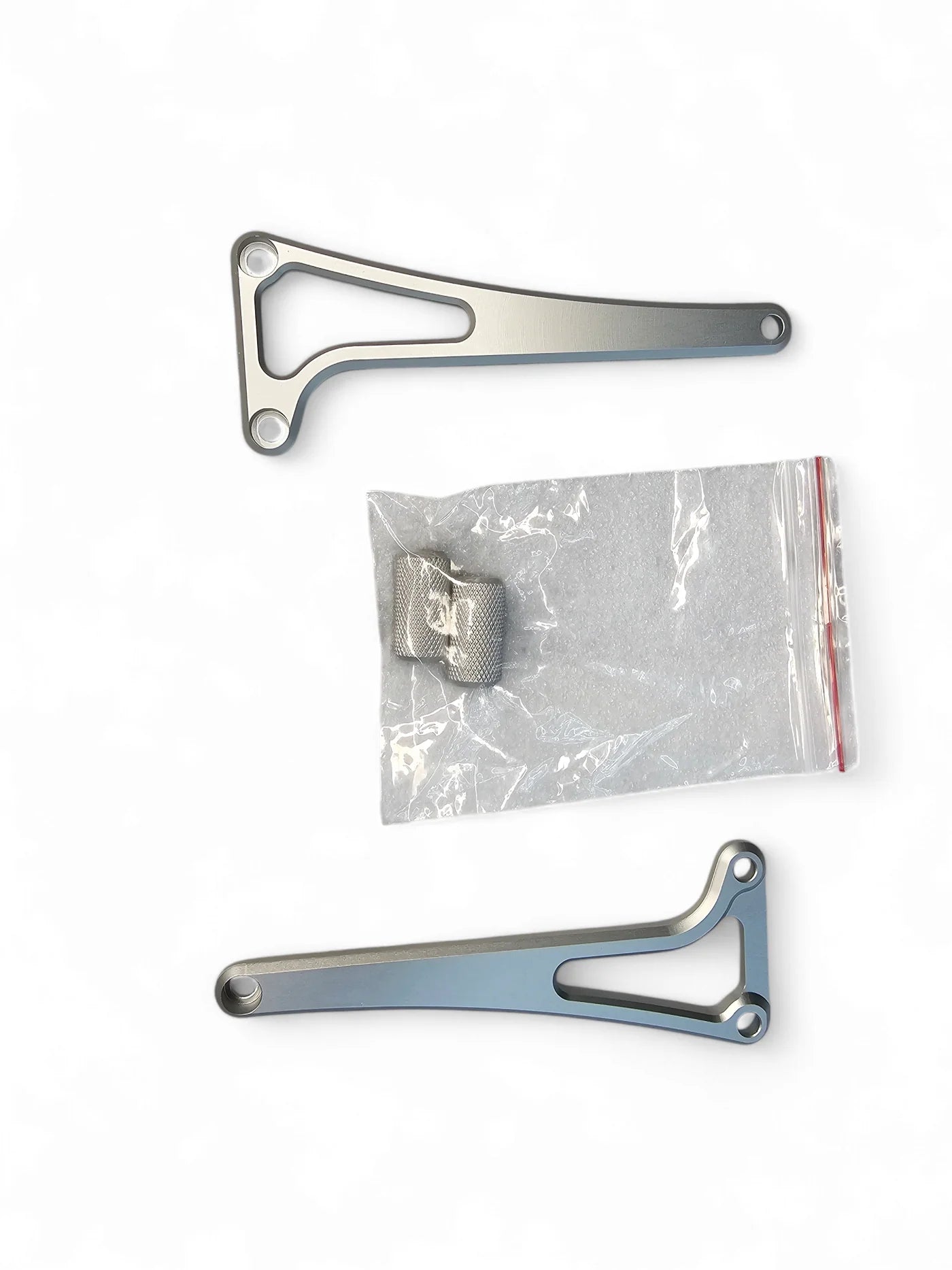 Metal brackets and a plastic bag with a bracket on a white background