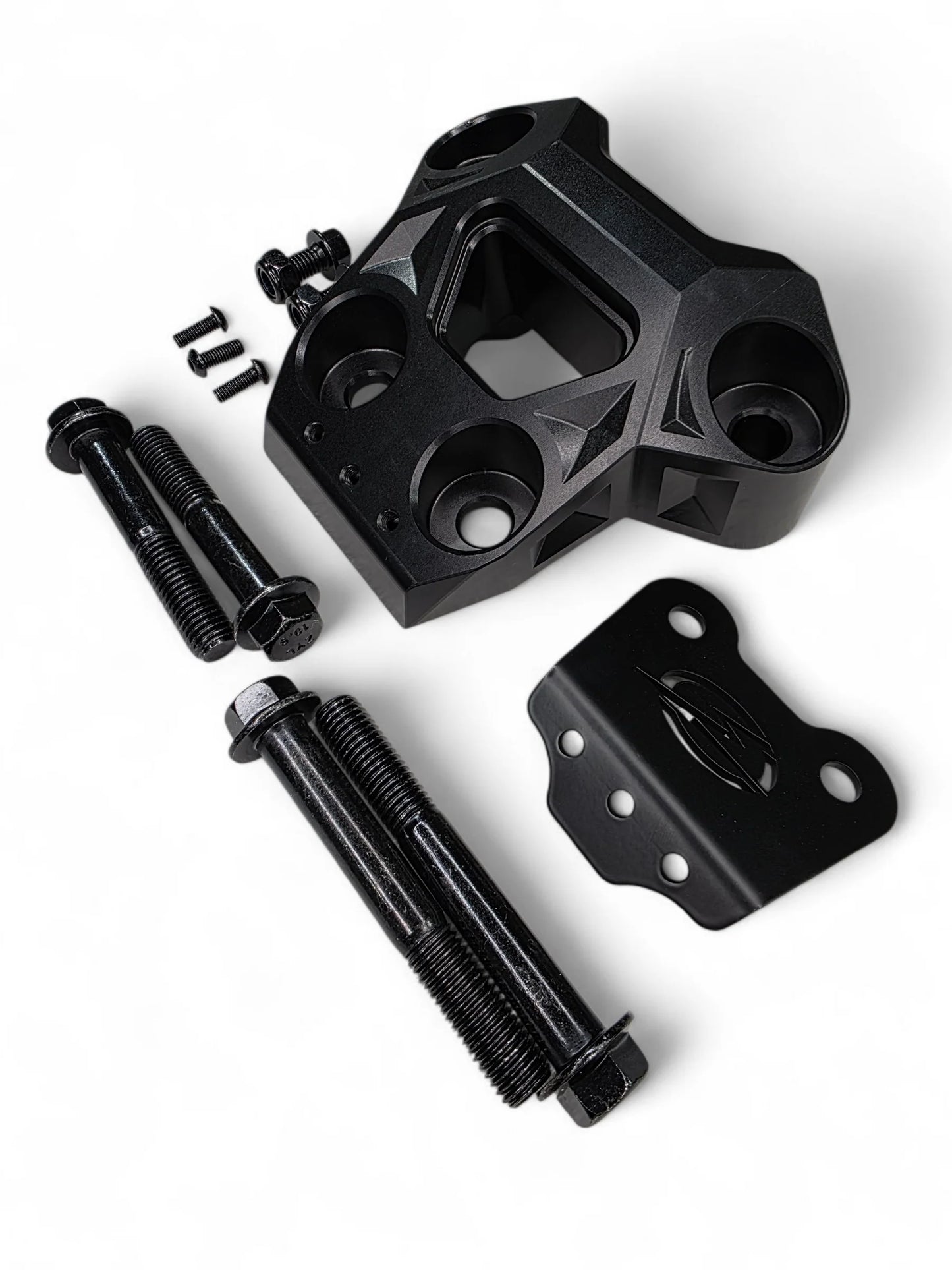 Black mechanical components including a large bracket, bolts, and a smaller metal piece on a white background.