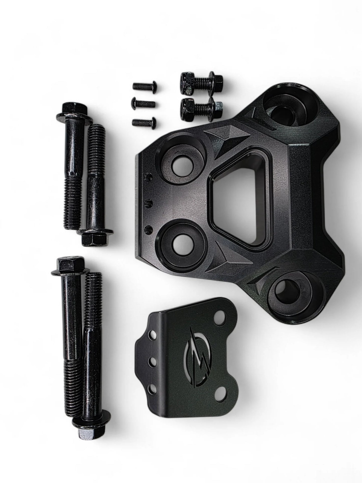 Black mechanical component with bolts on a white background