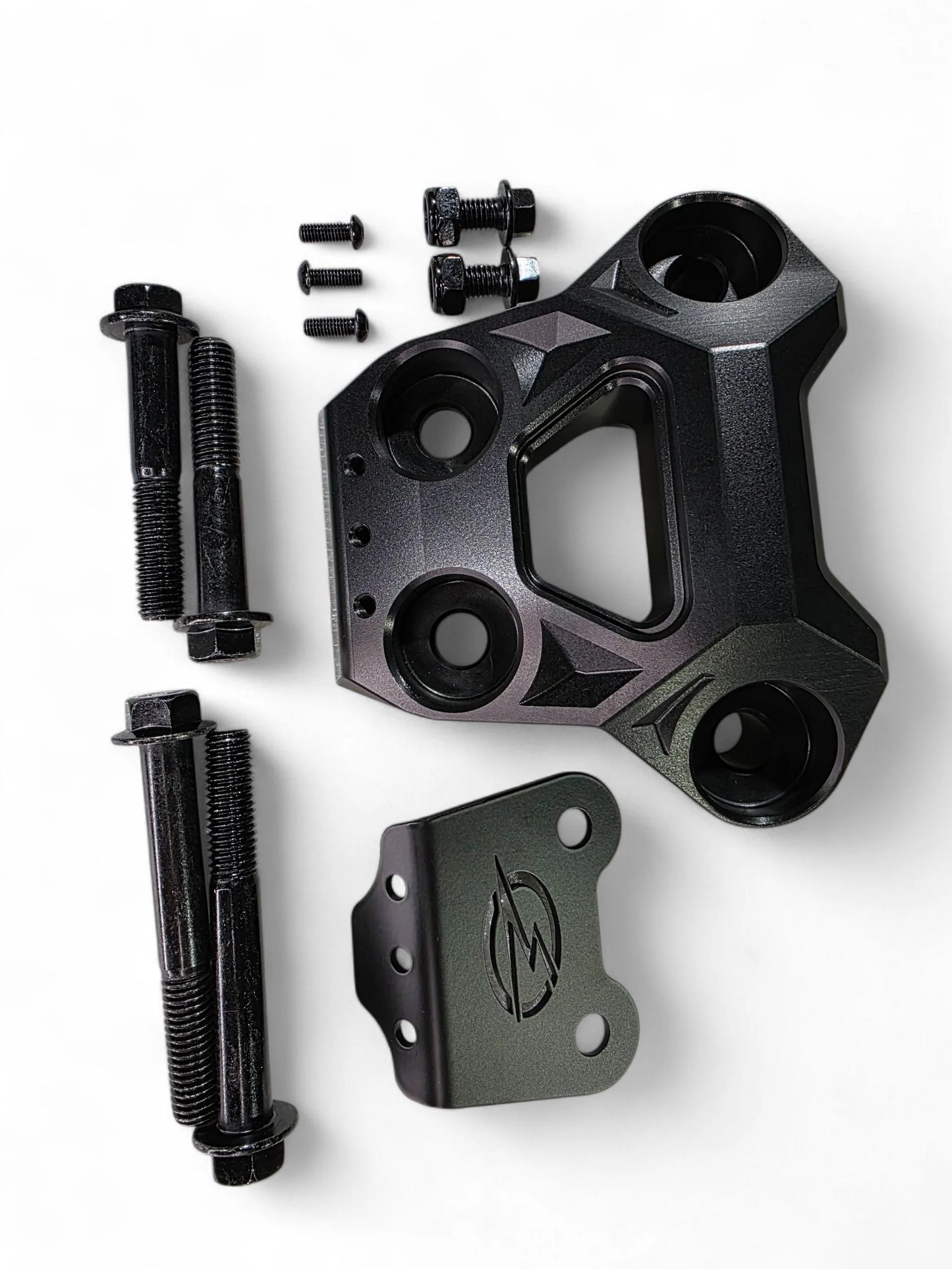 Black metal mechanical component with bolts on a white background