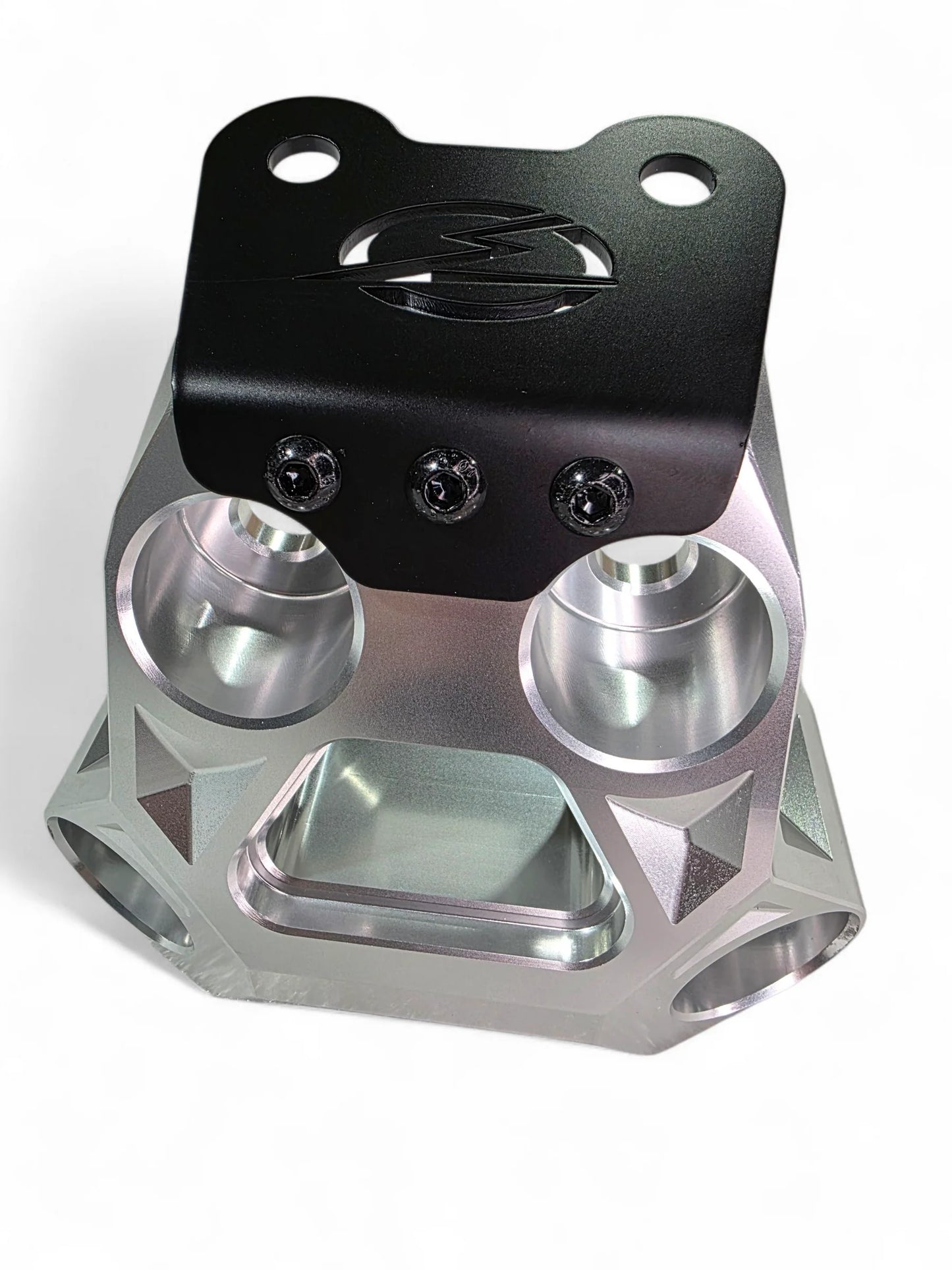Metallic mechanical component with black top section on a white background