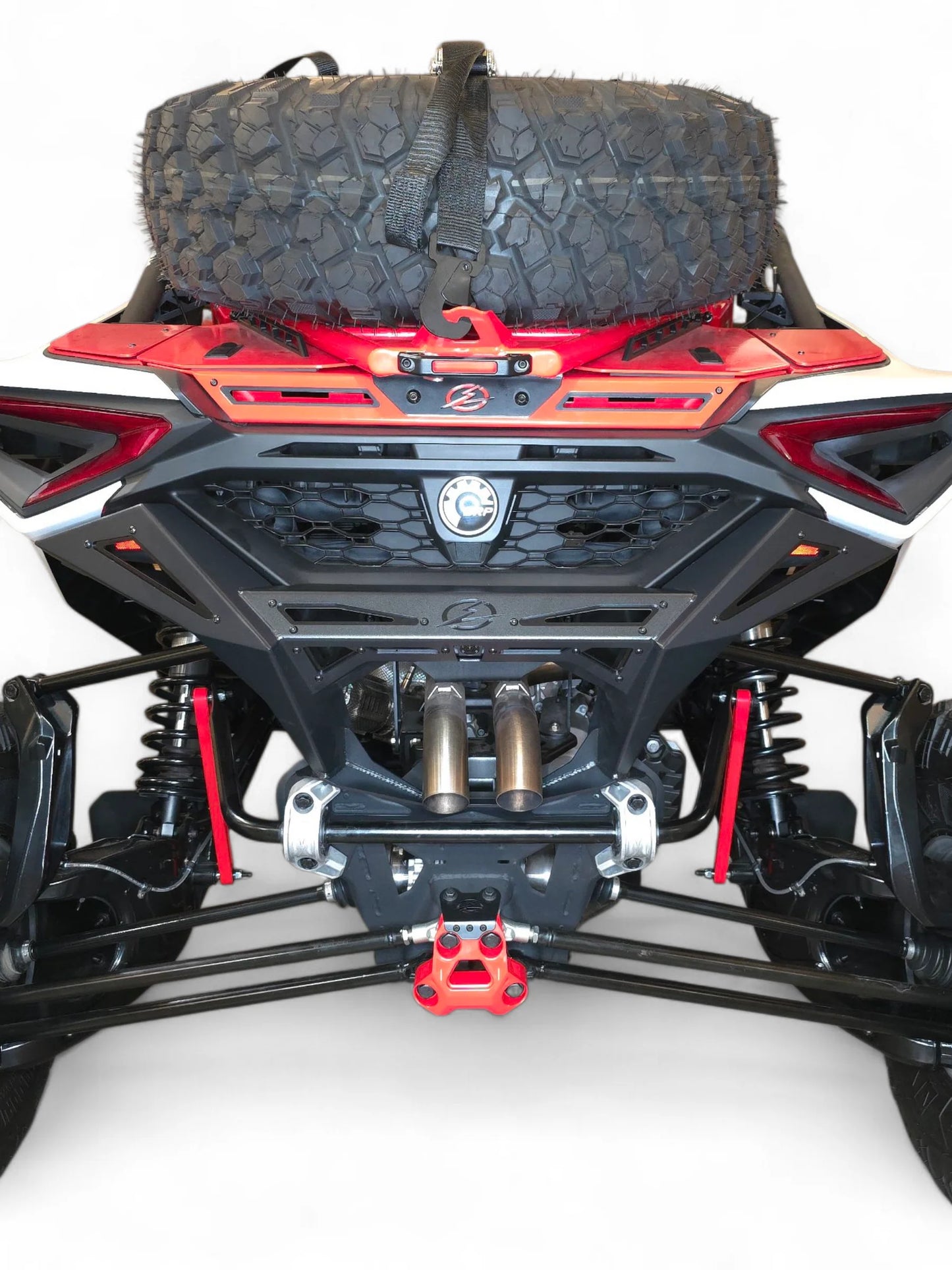 Close-up of a vehicle's undercarriage with visible suspension and branding on a white background