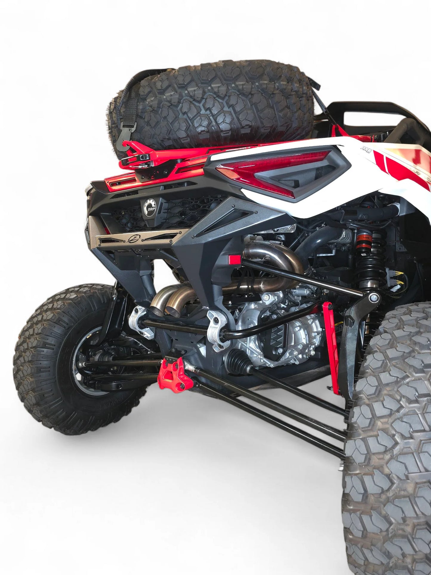 Close-up of a four-wheeler with visible suspension and tires on a white background
