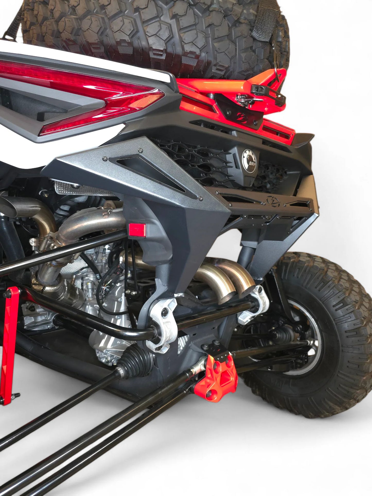 Close-up of a motorcycle's suspension system with red accents on a white background