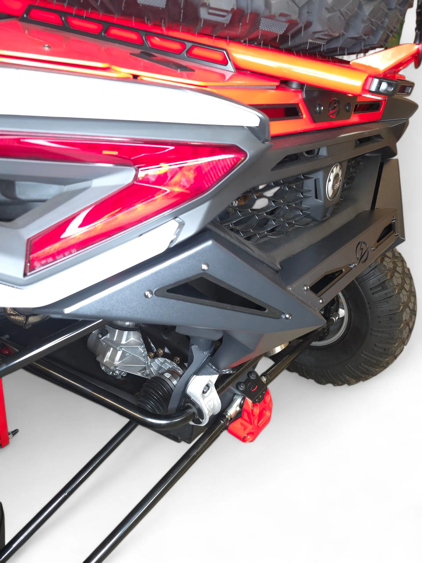 Close-up of a motorcycle's rear section with red and black design on a white background