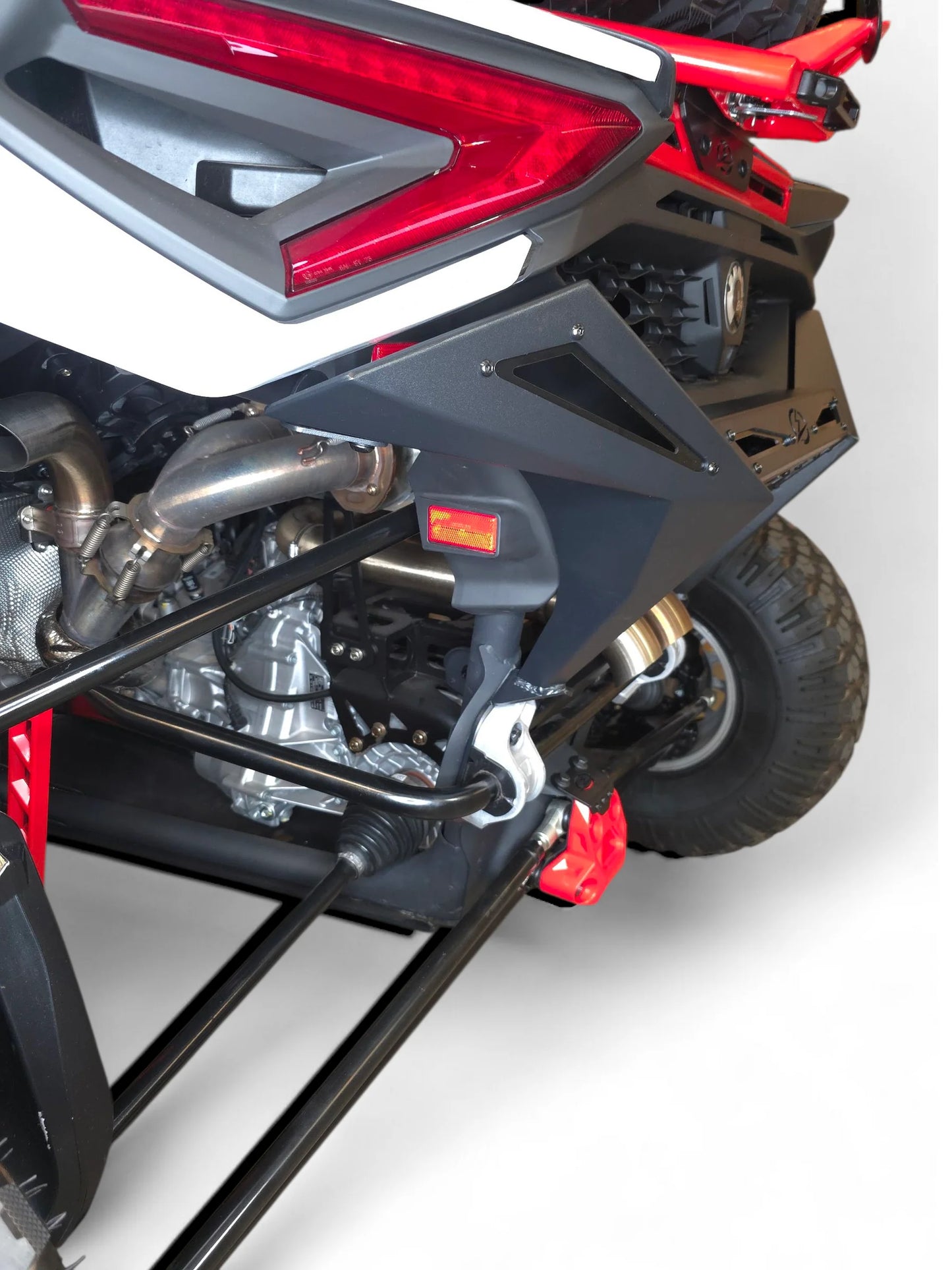 Close-up of a motorcycle's rear section with red and black design on a white background