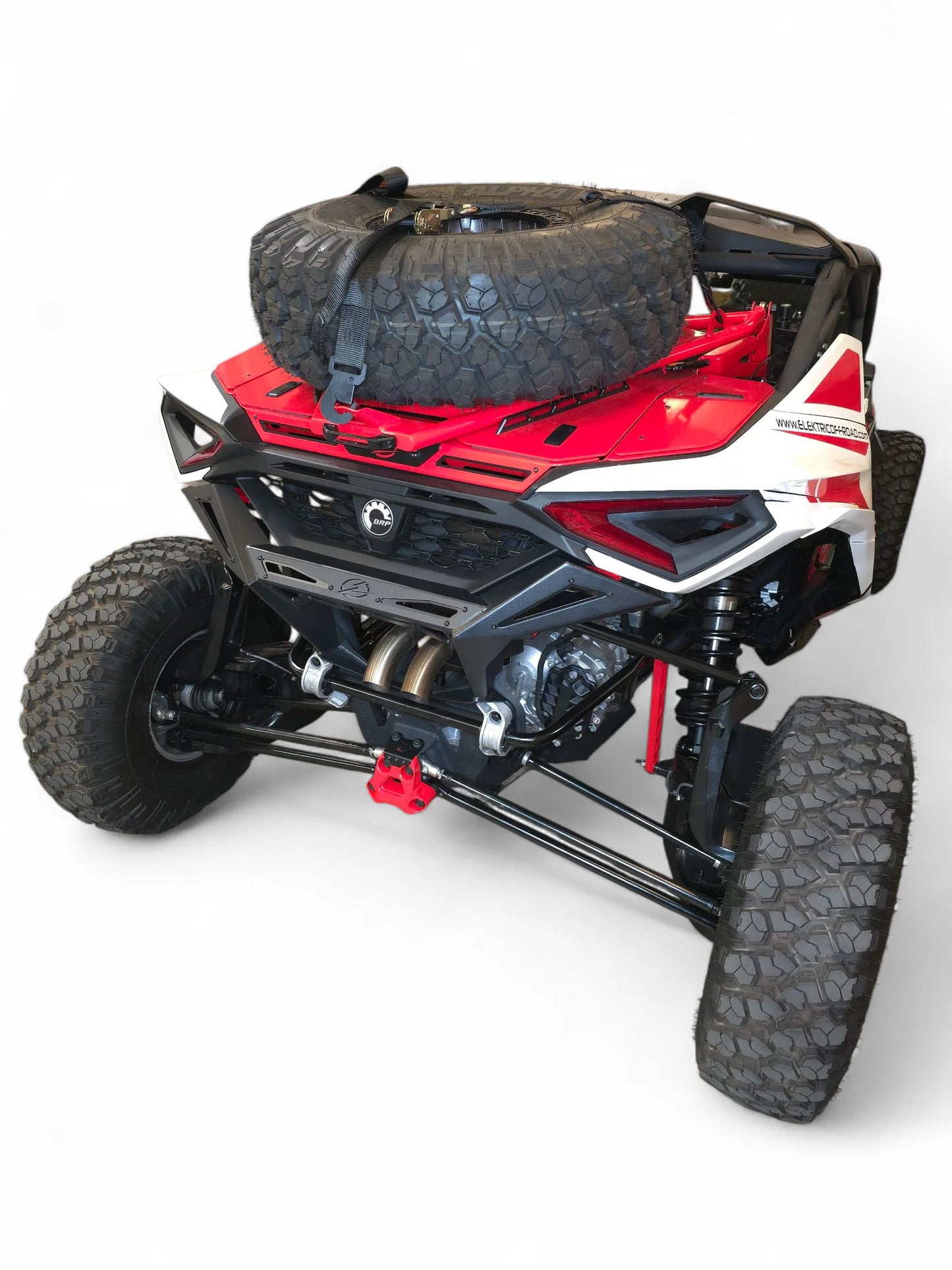 Red and black off-road vehicle with a spare tire on a white background