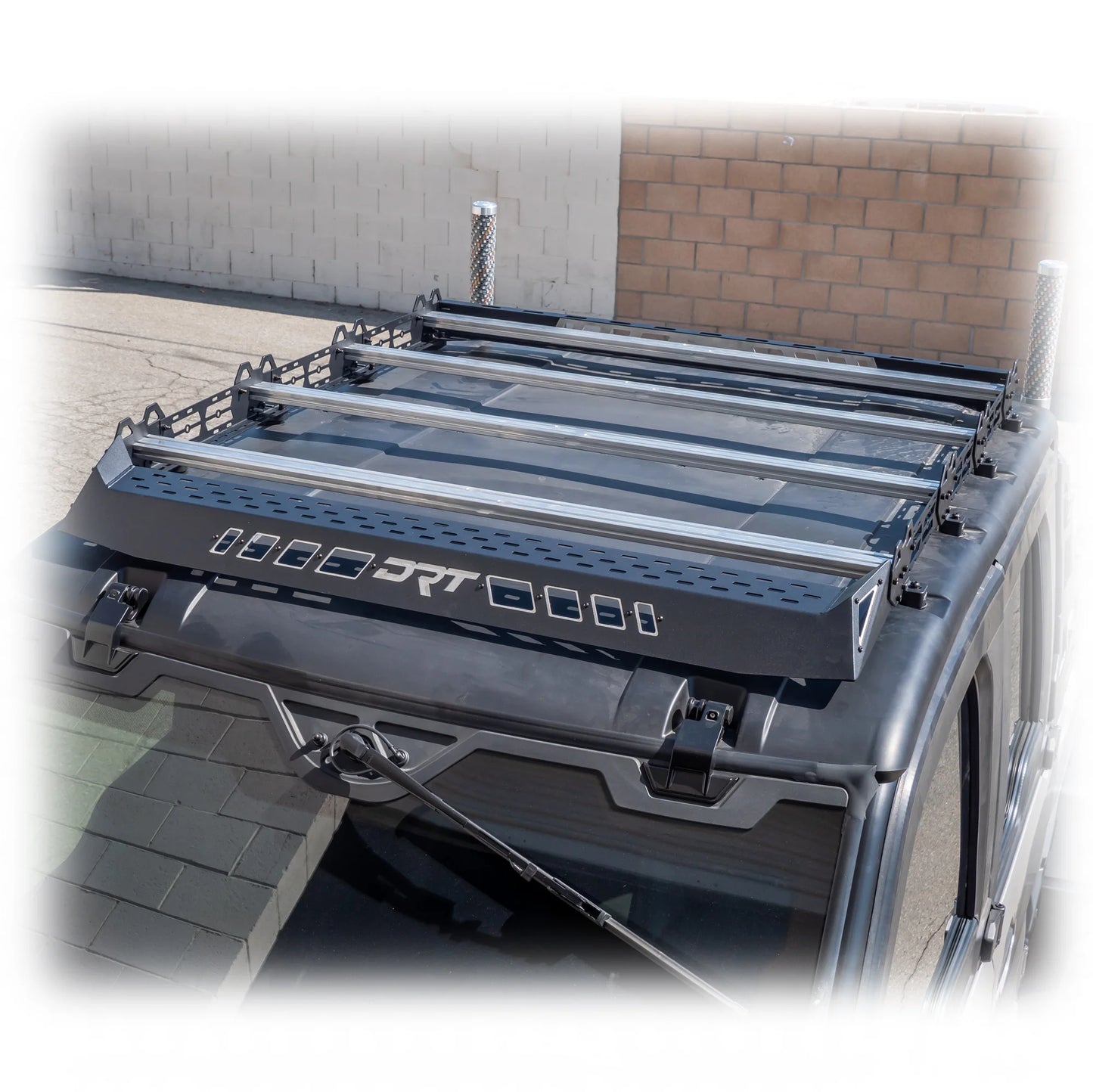 Roof rack system on a vehicle with visible branding in an outdoor setting.