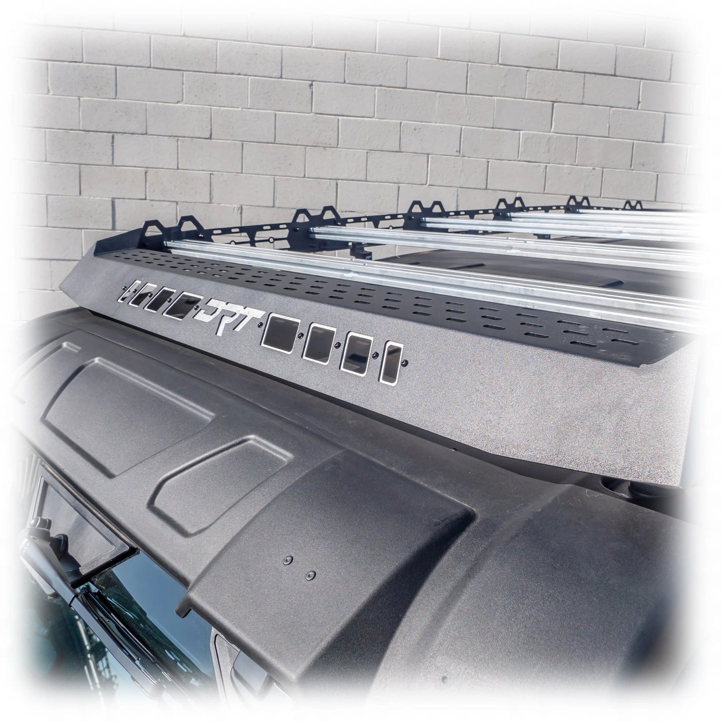 Car roof rack system on a vehicle with a tiled wall background