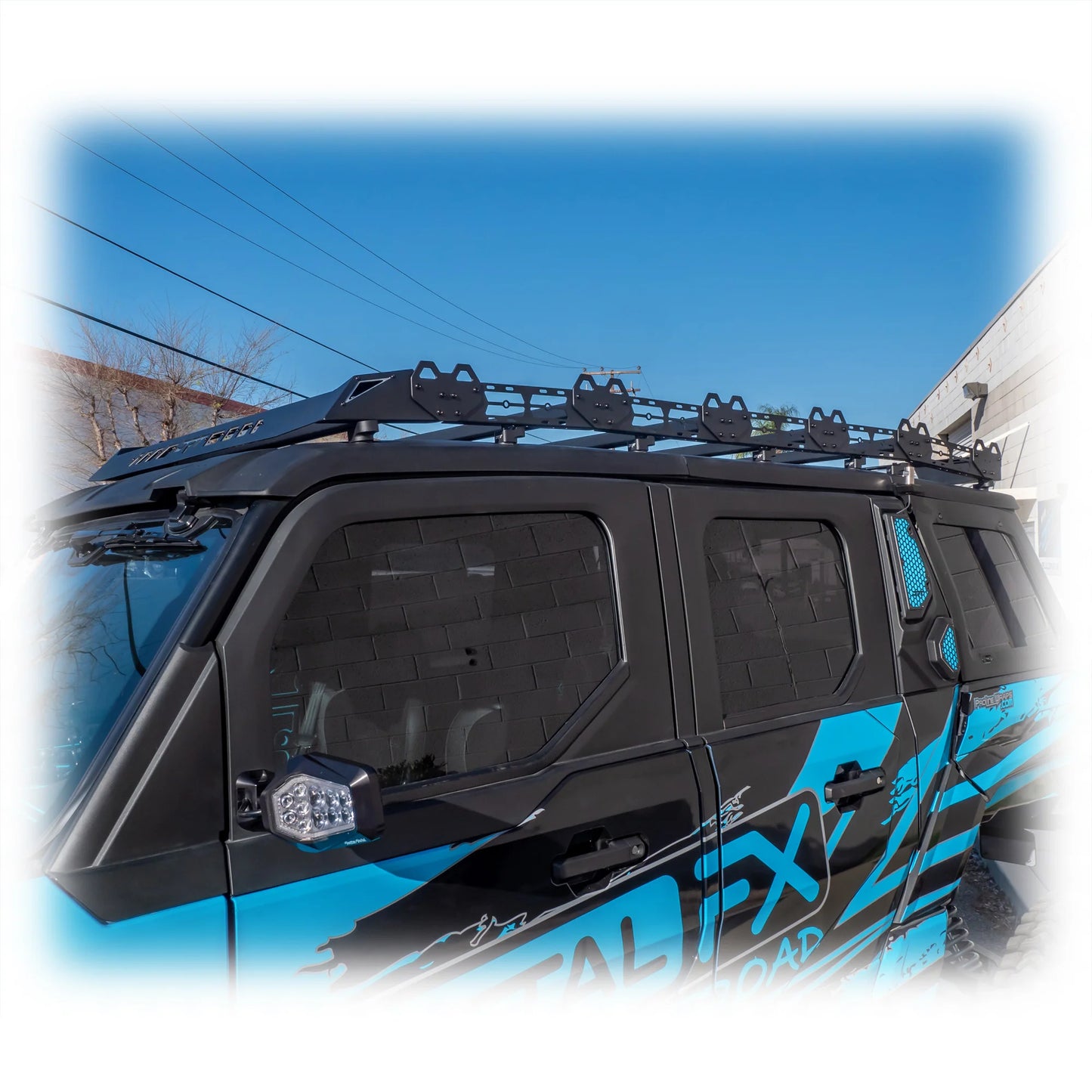 Black roof rack on a blue vehicle with clear sky background