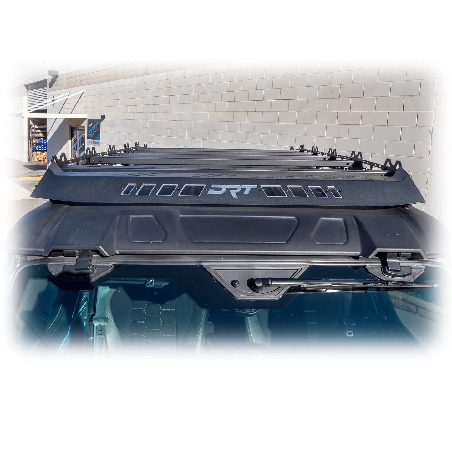 Car roof rack with 'DRT' branding against a building background
