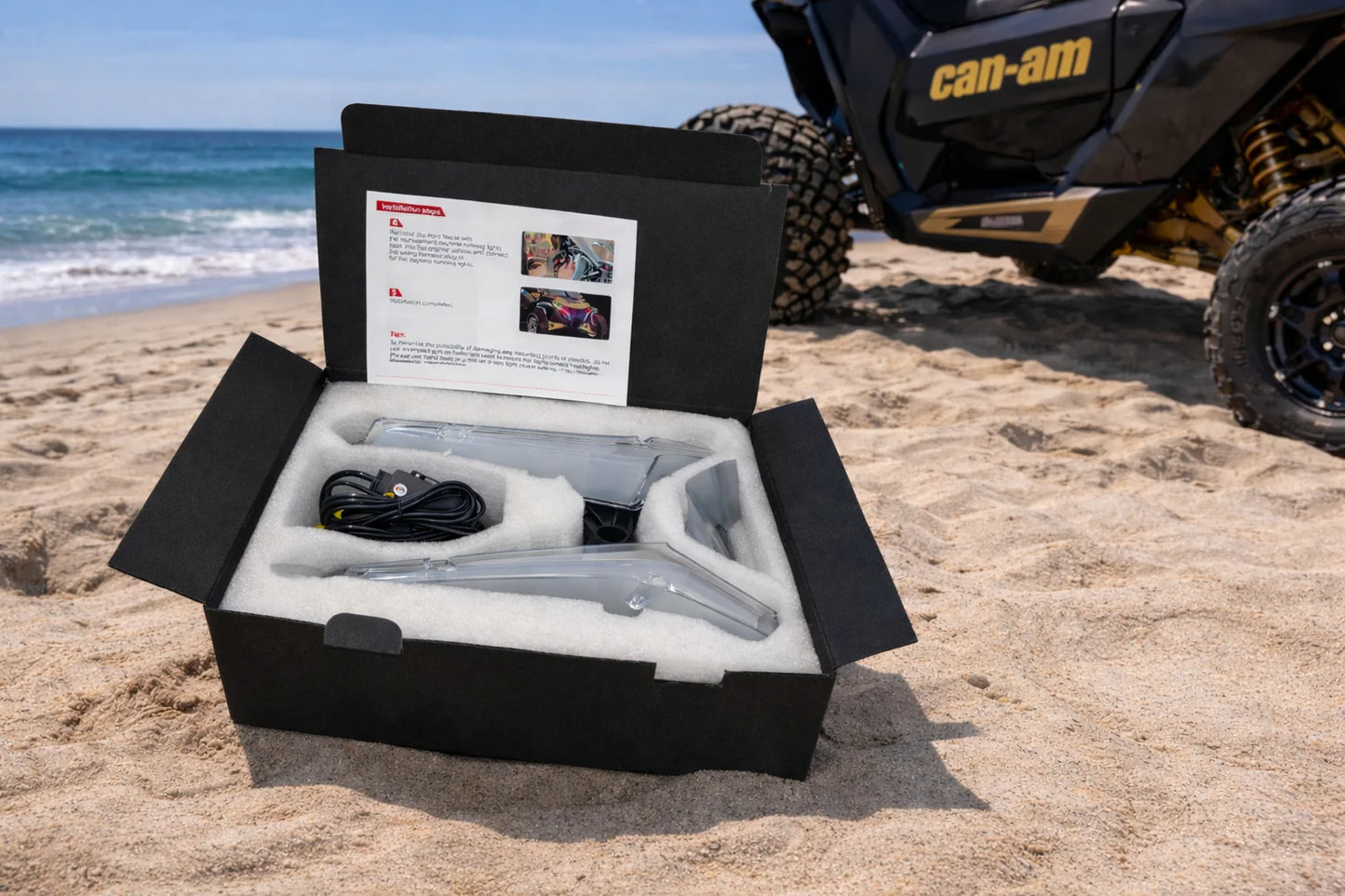 Product packaging on a beach with a Can-Am vehicle in the background