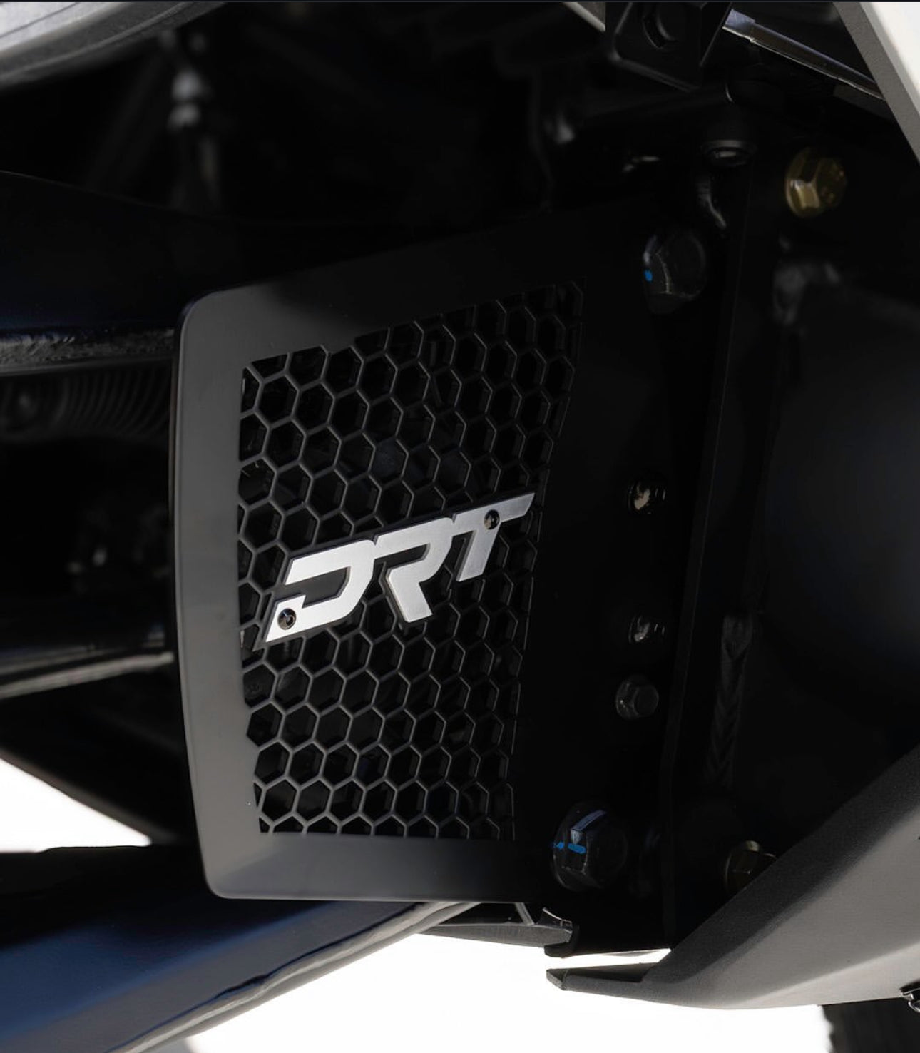 Motorcycle radiator guard with DRT logo on a white background