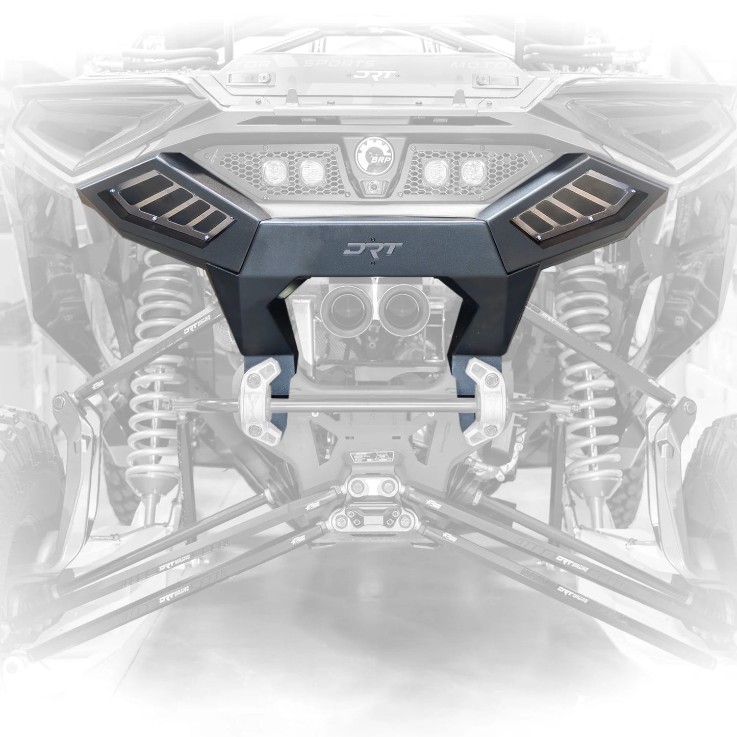 Close-up of a vehicle grille with 'DRT' branding on a white background