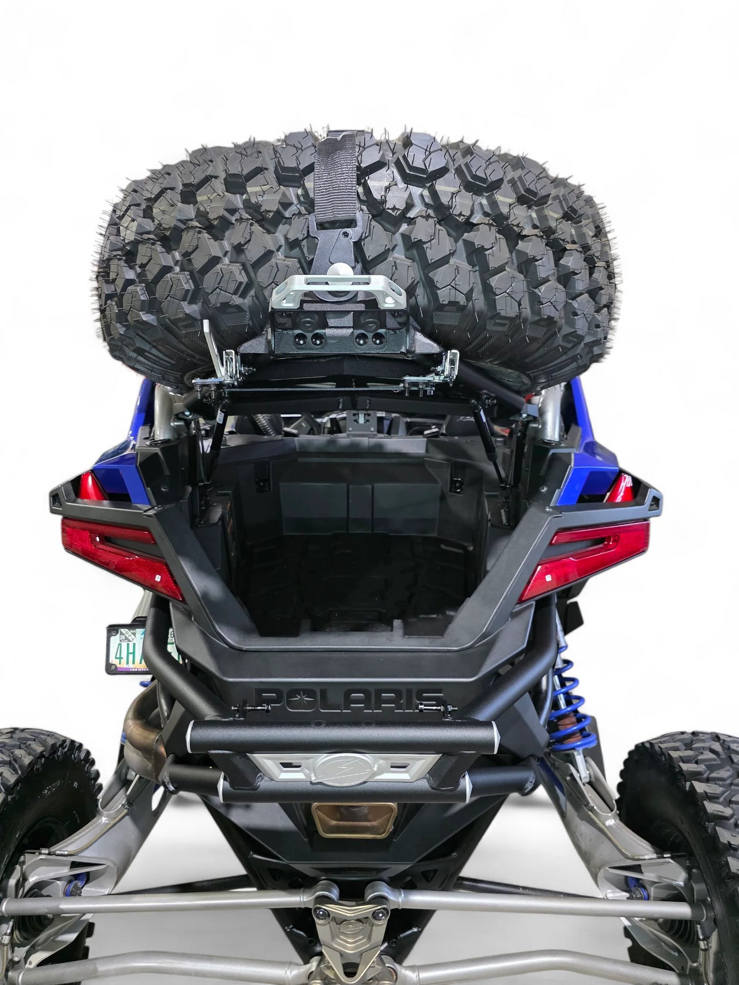Back view of a Polaris vehicle with a large tire mounted on a white background