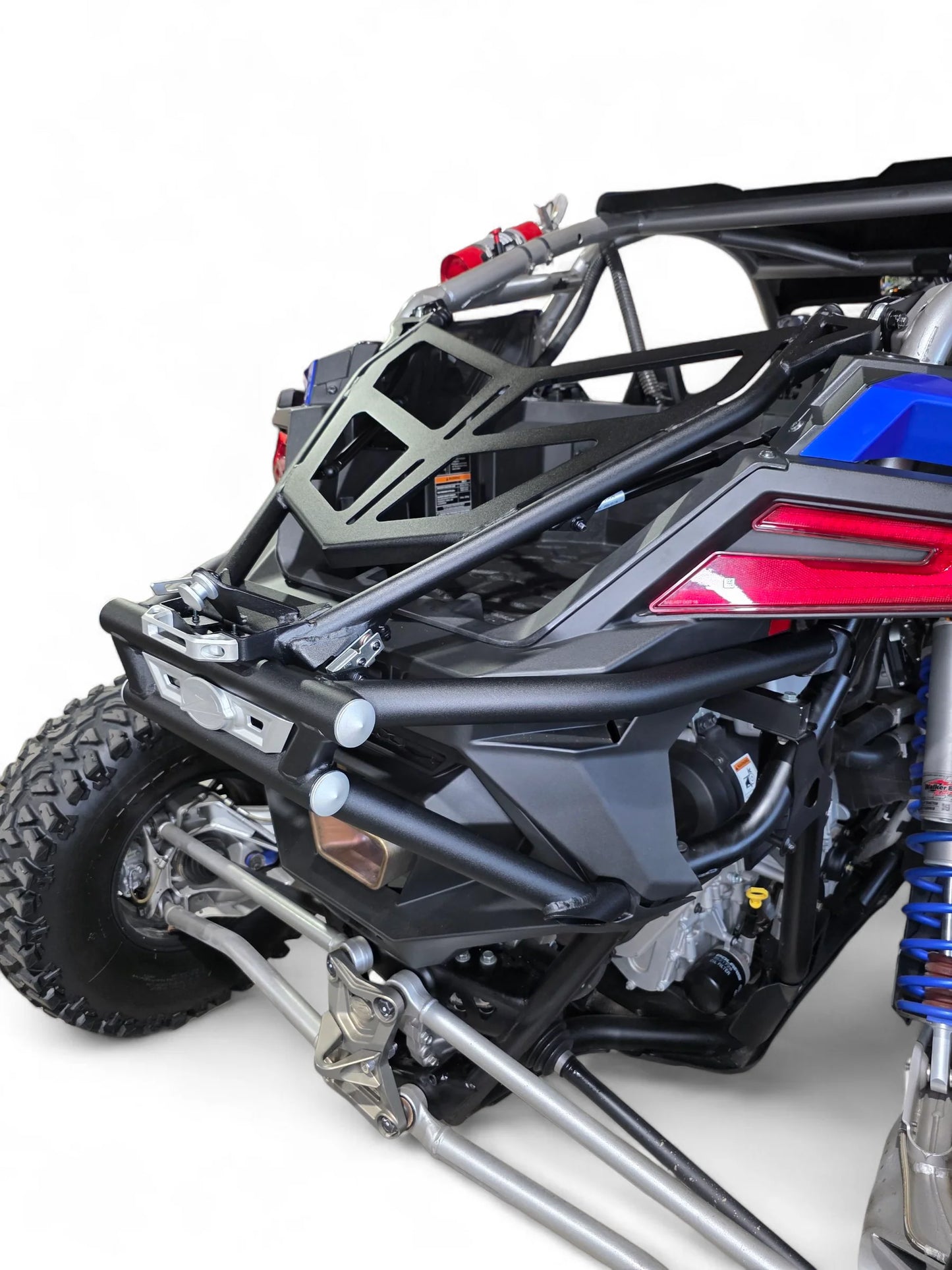 Close-up of a black off-road vehicle with visible suspension and bodywork on a white background