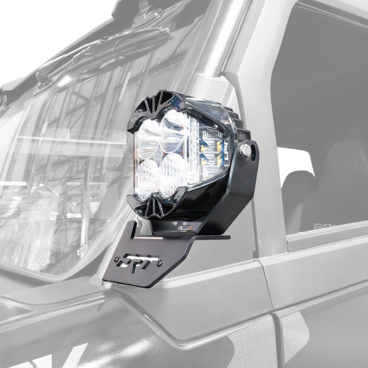 Car fog light mounted on a vehicle with a visible brand logo.