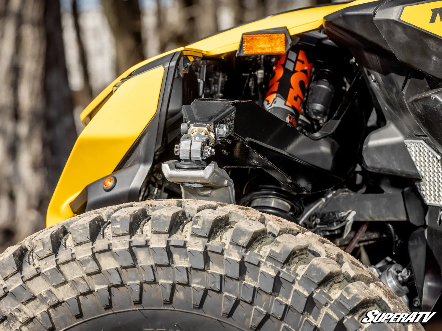 Close-up of a SuperATV product with a forest background
