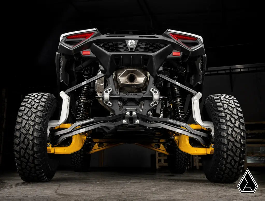 Front view of a rugged off-road vehicle with visible suspension and tires on a dark background.