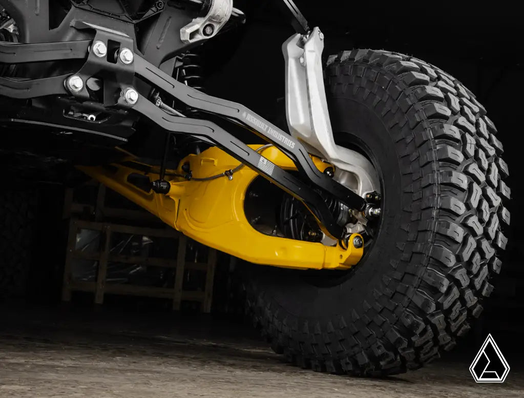 Close-up of a vehicle's suspension system with a yellow shock absorber on a dark background.