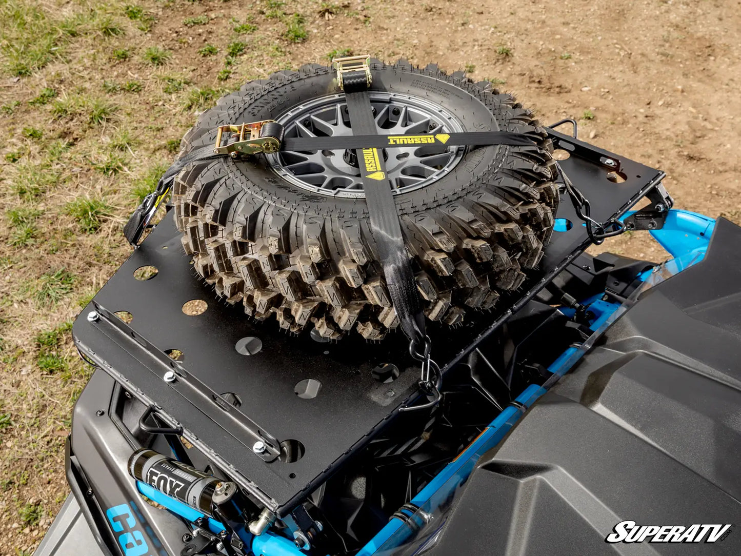 Off-road vehicle with a spare tire mounted on the roof, featuring SuperATV branding.