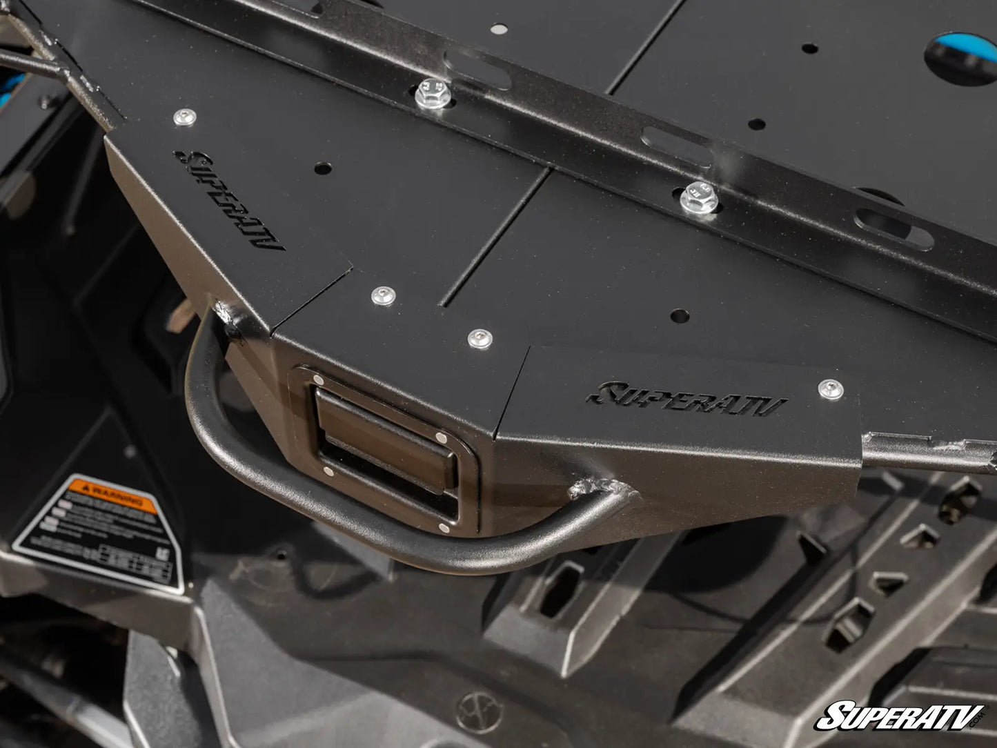 Metal protective guard with SuperATV branding on a vehicle component.