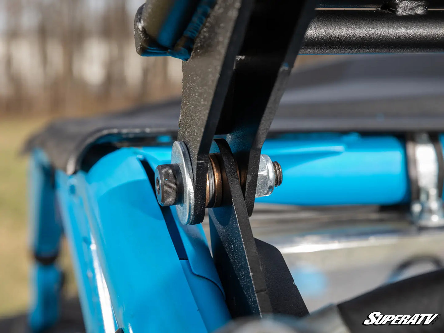 Close-up of a blue ATV with a belt and pulley system, featuring the SuperATV logo.