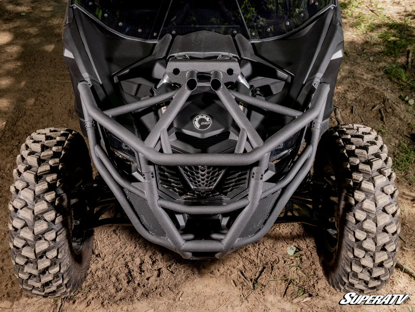 Close-up of an ATV with a SuperATV logo on a dirt surface