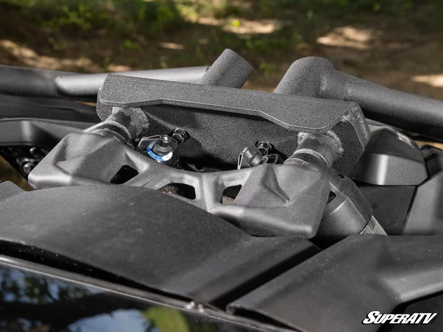 Close-up of a SuperATV product with a blurred natural background