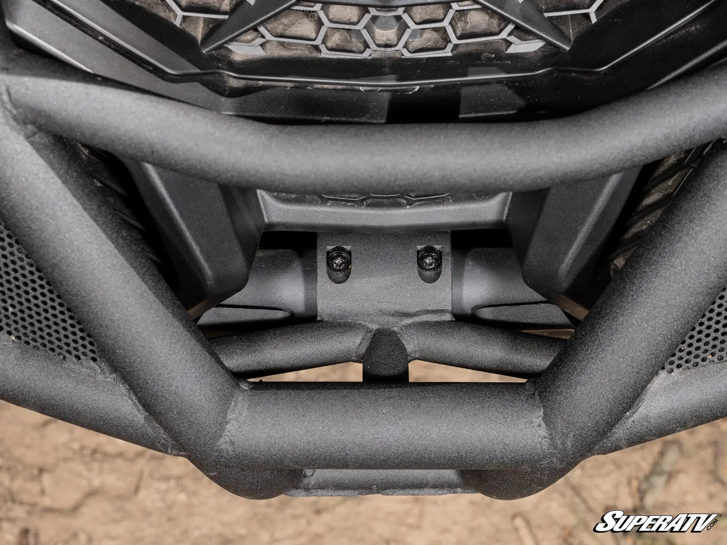 Close-up of a SuperATV bumper on an ATV with a textured background