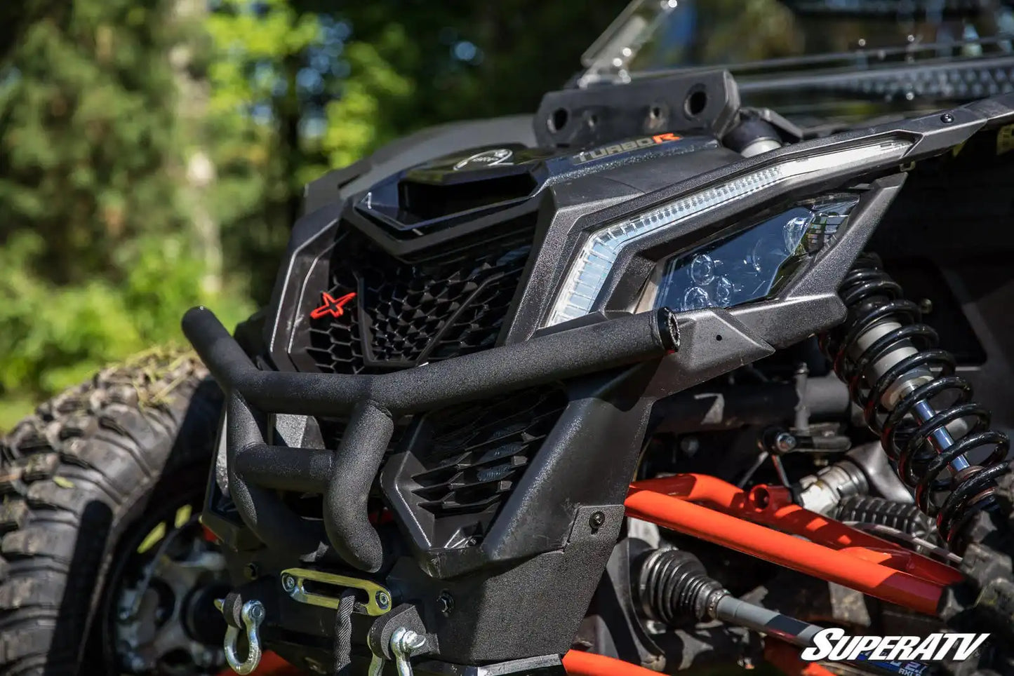 Close-up of a SuperATV vehicle with detailed mechanical components.