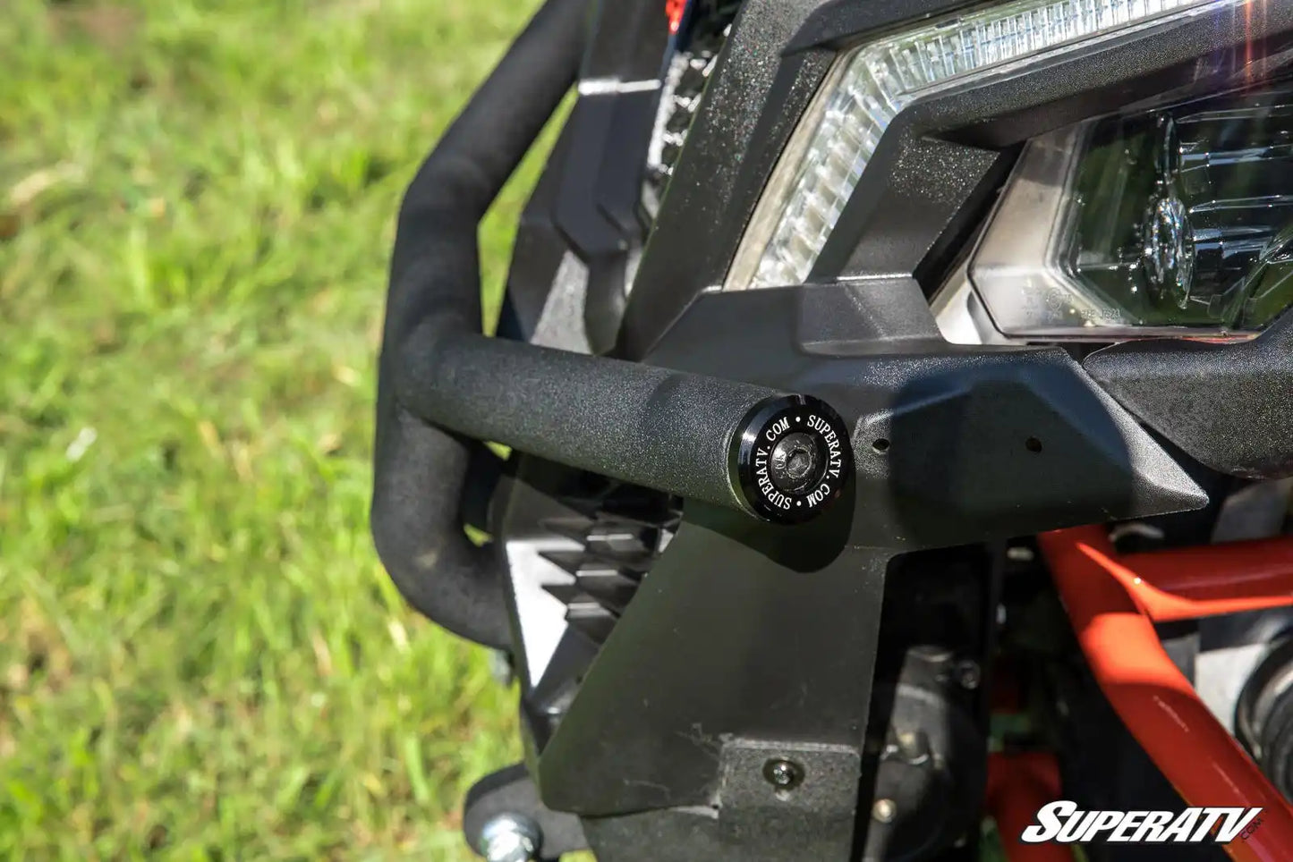 Close-up of a SuperATV product on an ATV with grass in the background