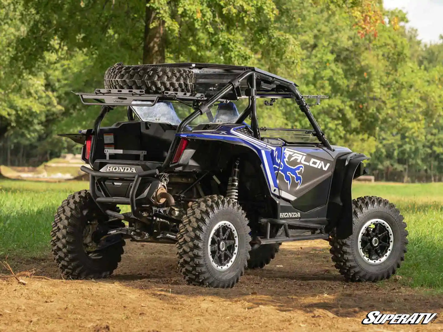 Honda Talon ATV on a dirt path with trees in the background
