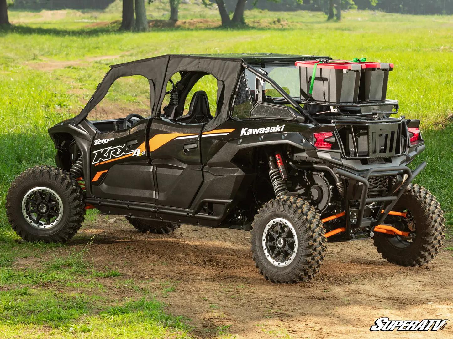 Kawasaki side-by-side vehicle on a dirt path with grass and trees in the background