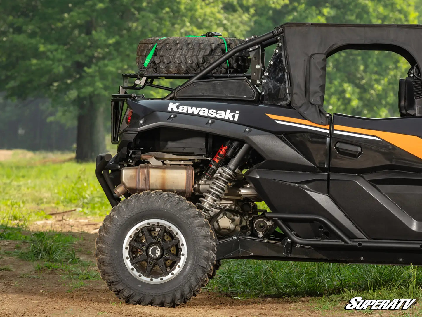 Kawasaki ATV with open door on a dirt path