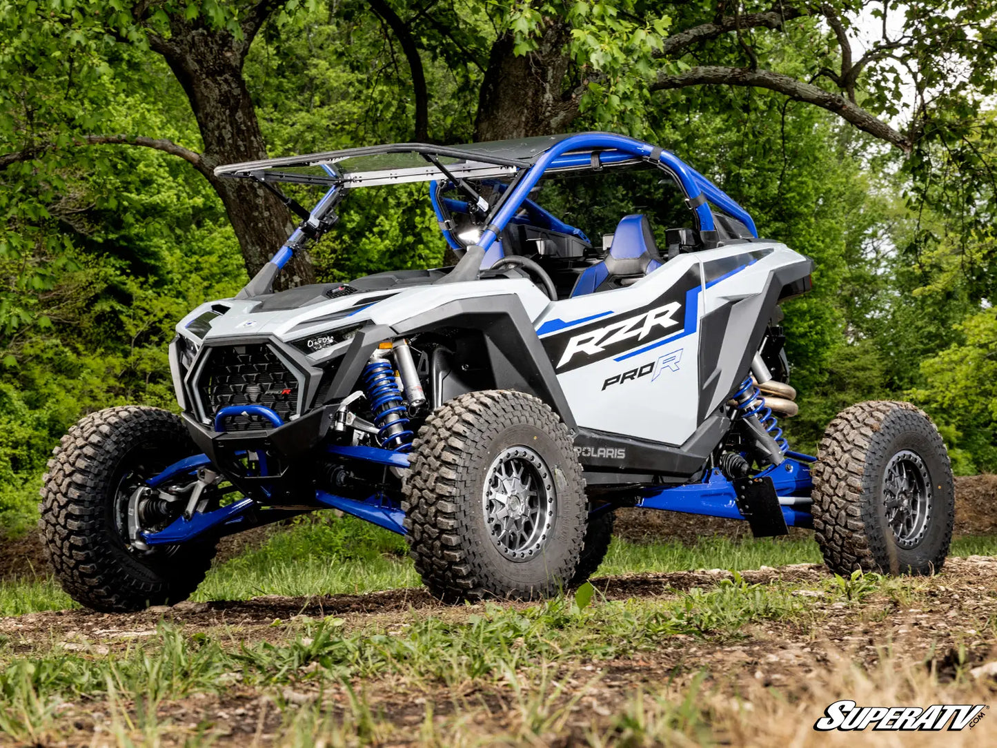 Off-road vehicle with 'SuperATV' branding on a natural background