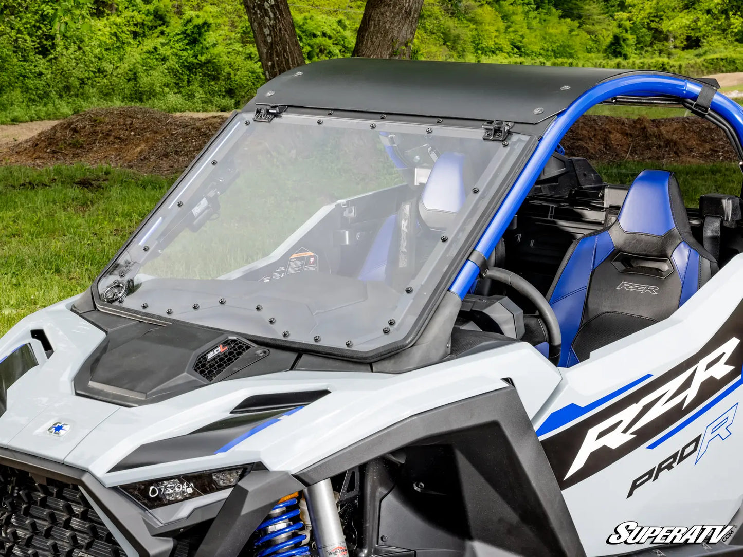 Side view of a Polaris RZR Pro R vehicle with blue interior and visible branding.
