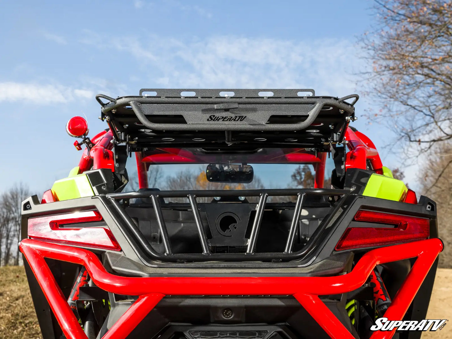 Red ATV with SuperATV branding on a clear day