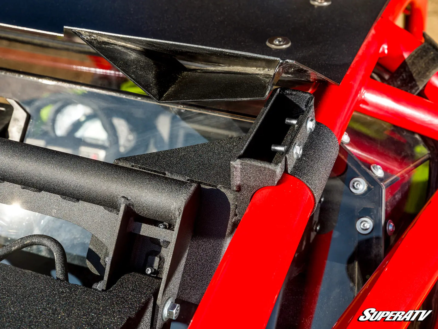 Close-up of a red and black ATV with SuperATV branding.