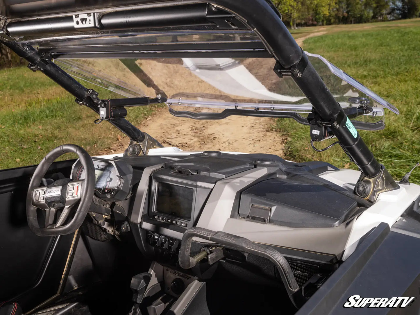 Close-up of a SuperATV vehicle interior with dashboard and steering wheel.