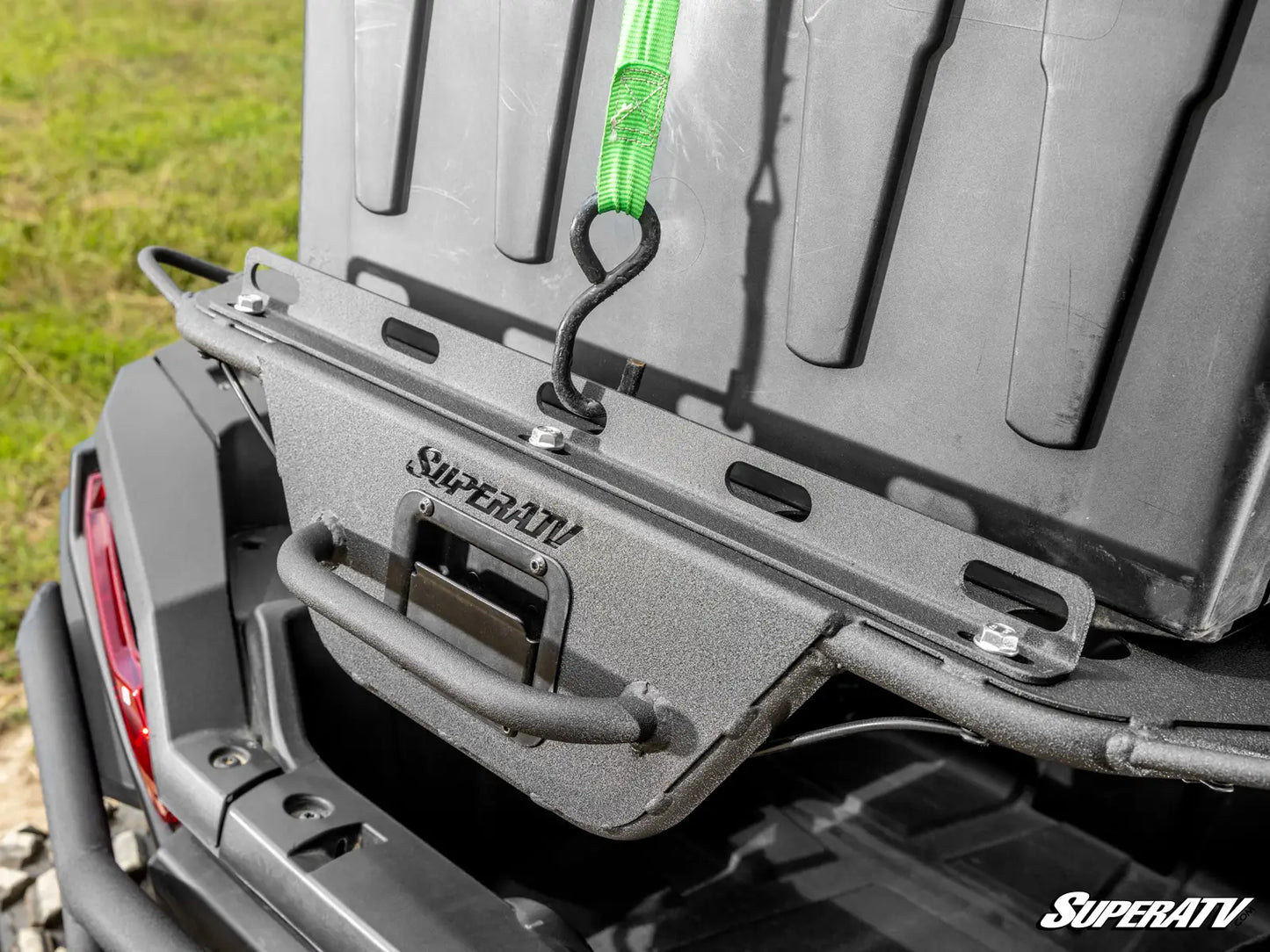 Close-up of a SuperATV bumper on a vehicle with grass in the background