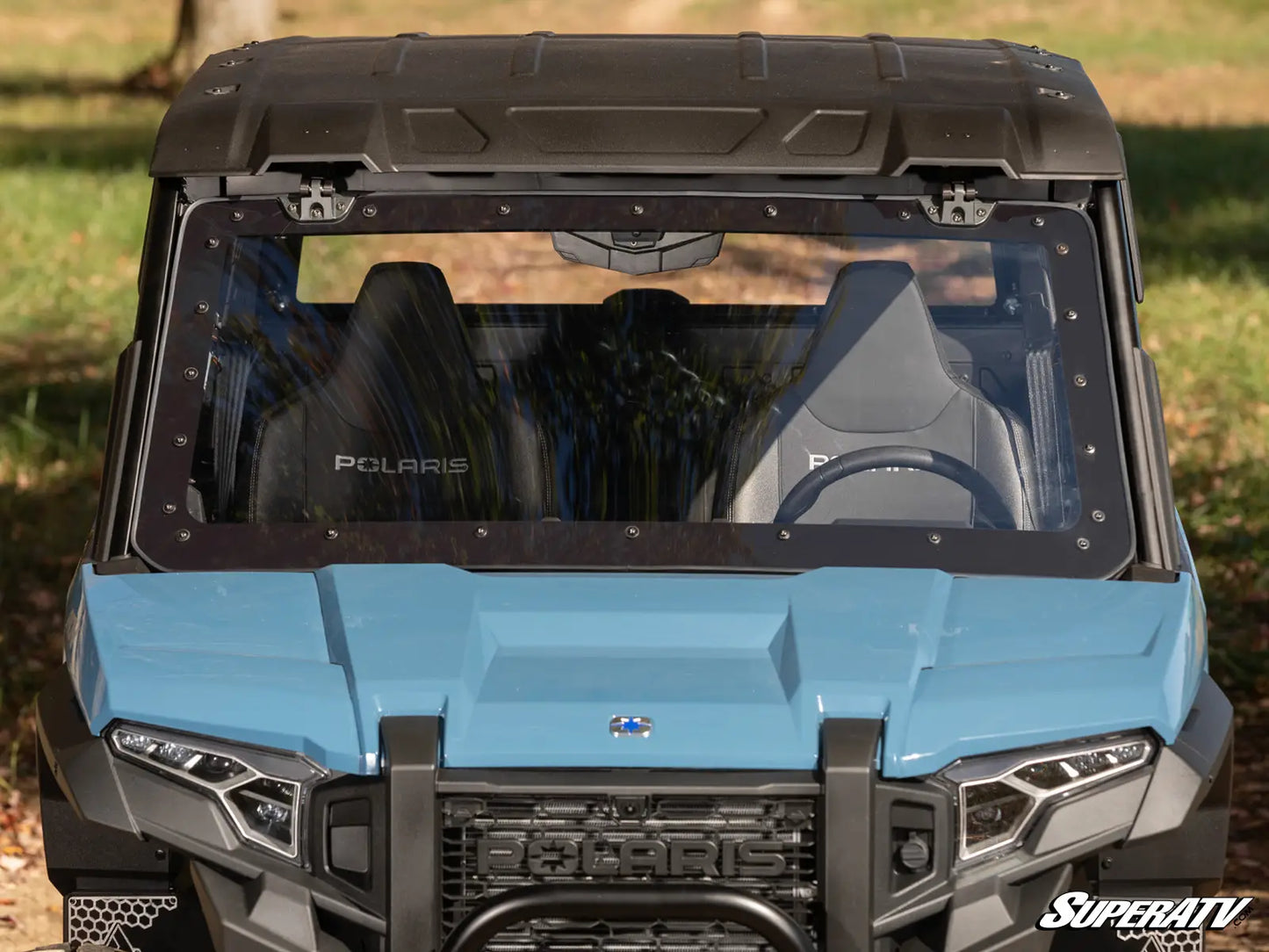 Front view of a Polaris SuperATV vehicle with a blue hood and black roof.