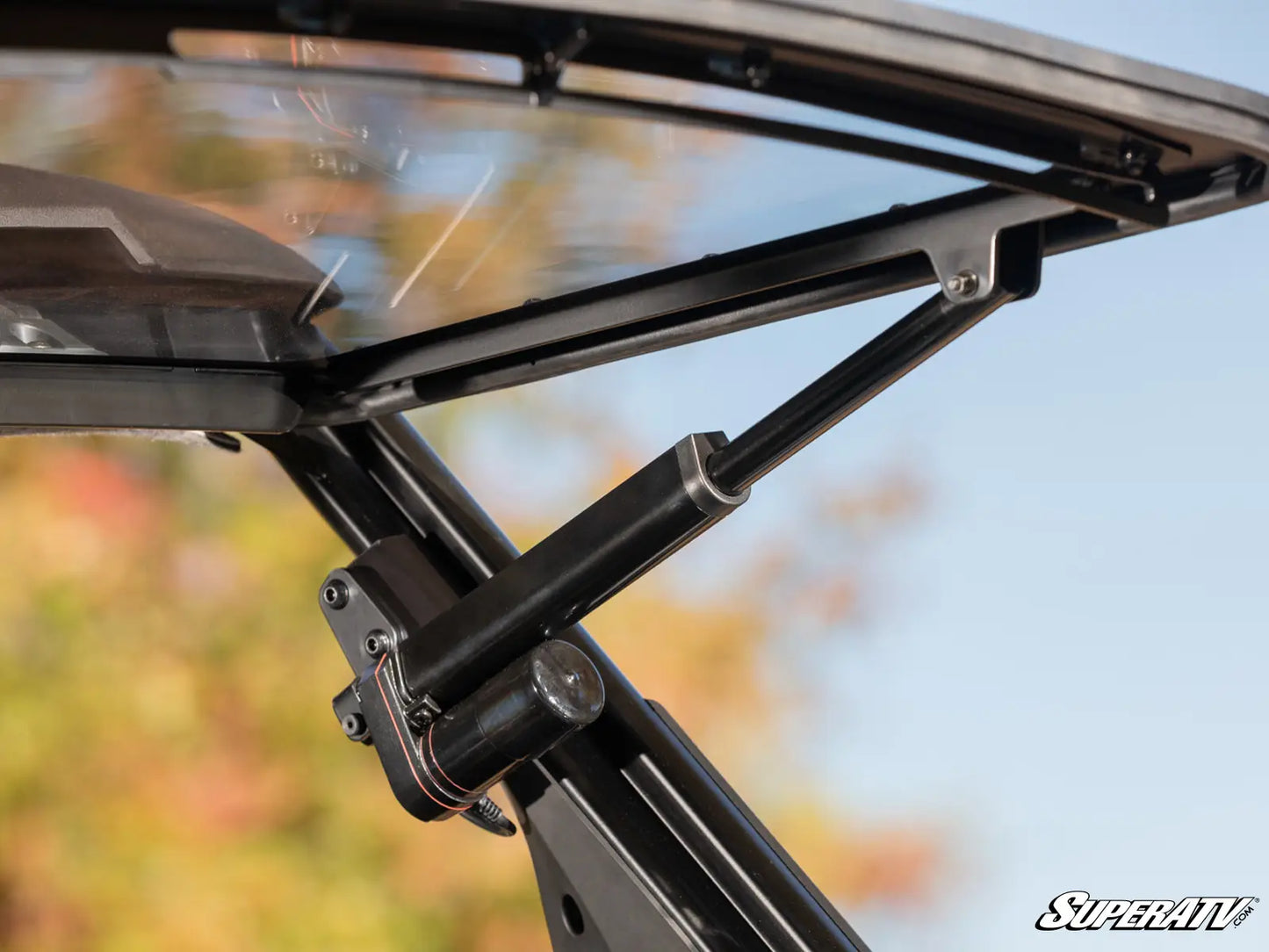 Close-up of a black metal rack with a blurred outdoor background