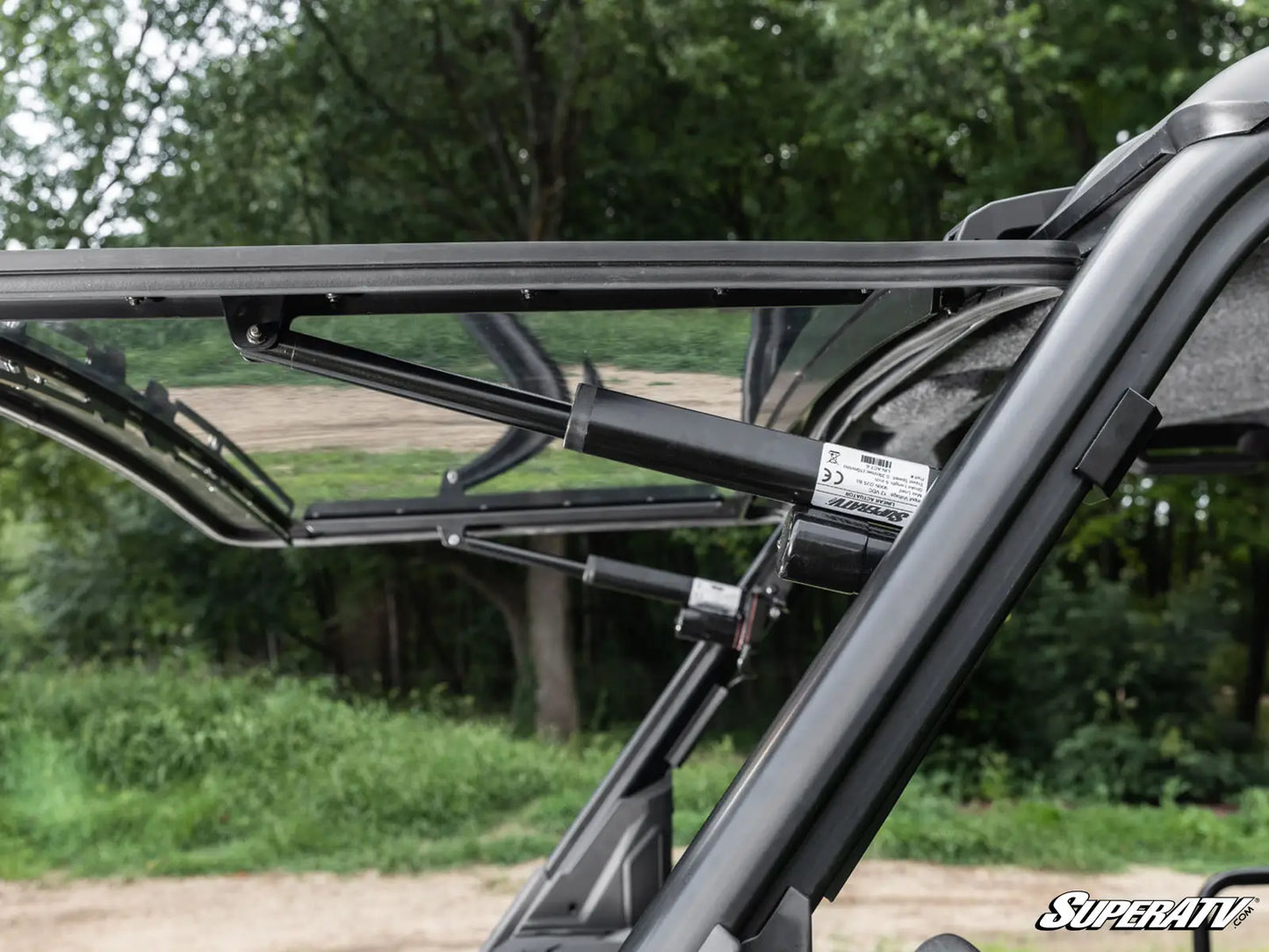 Close-up of a black roof rack system on a vehicle with a blurred natural background